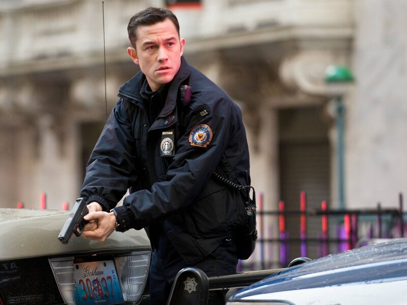 Officer holding gun in city
