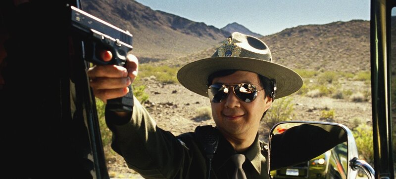 Officer holding gun in desert
