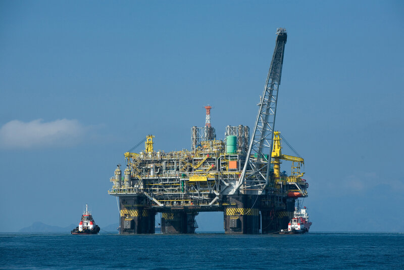 Offshore oil platform with tugboats
