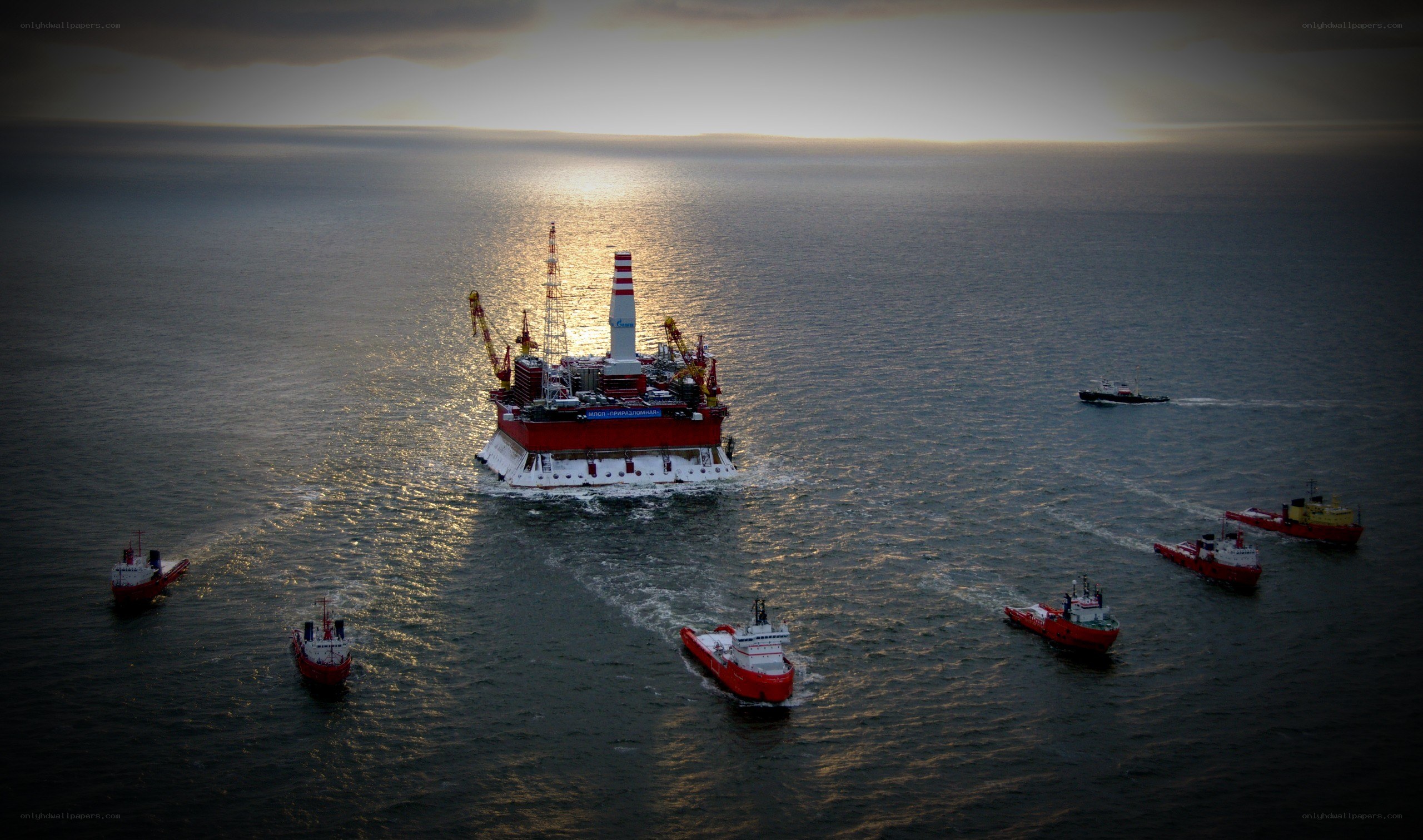 Offshore oil rig with support vessels