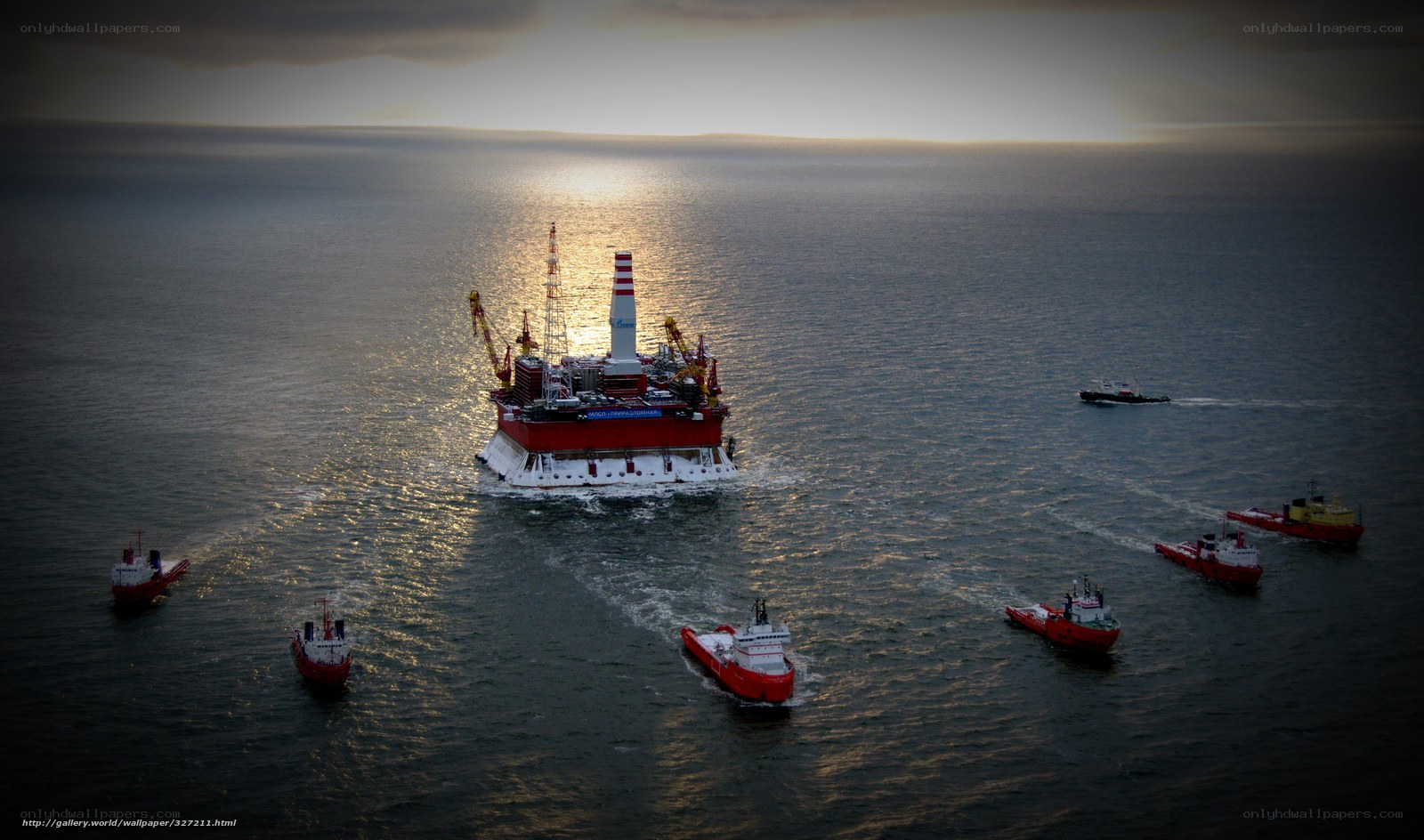 Offshore oil rig with support vessels