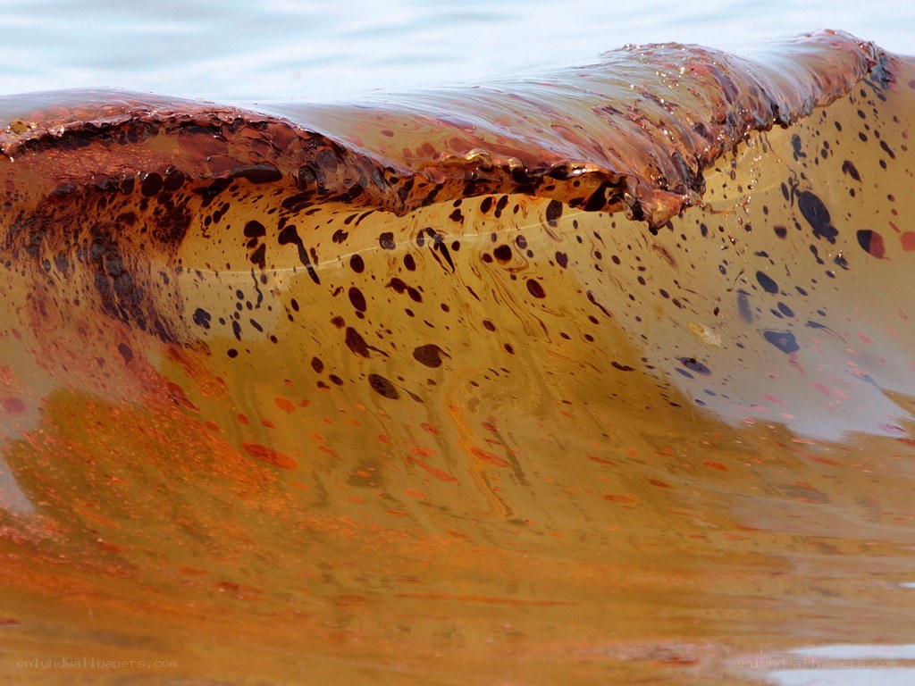 Oil-covered wave in the ocean