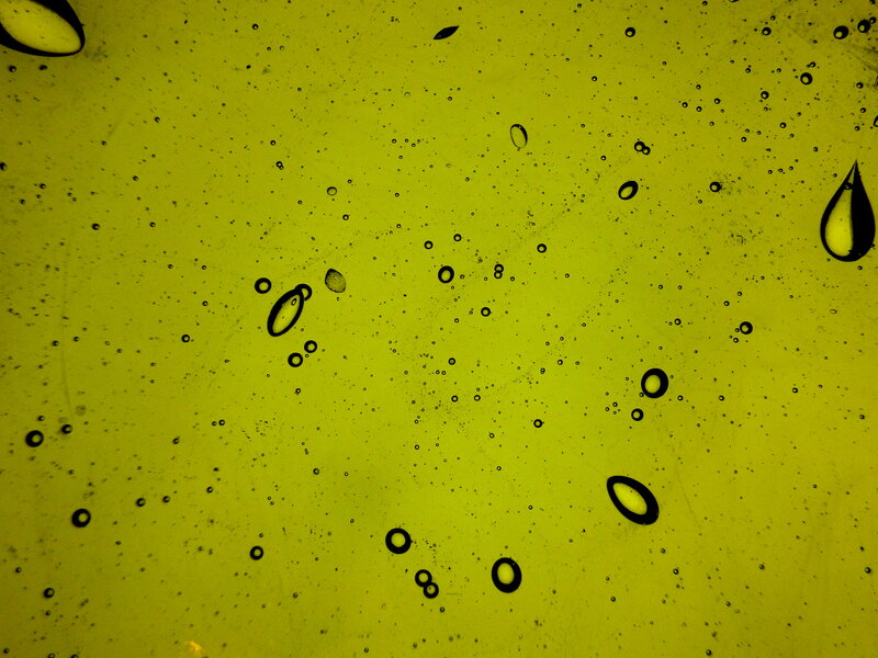 Oil Droplets on Yellow Surface