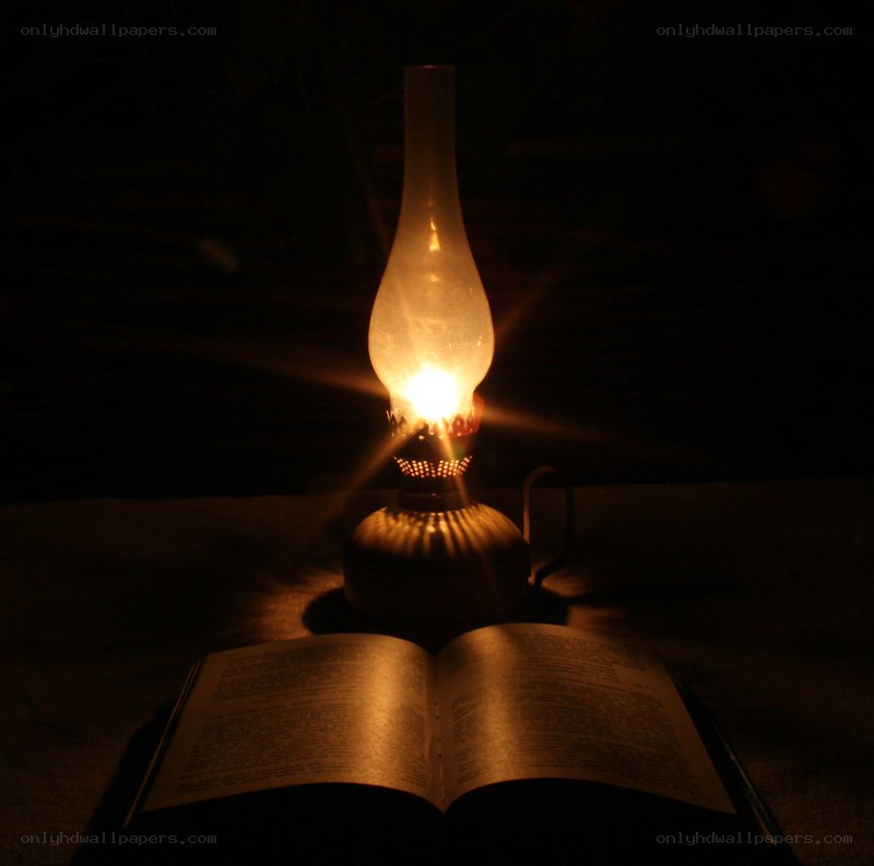 Oil lamp illuminating a book