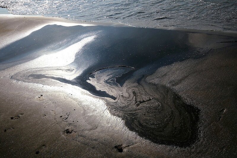 oil spill on sandy beach