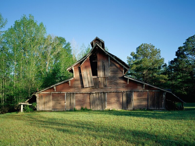 Old barn in a grassy field