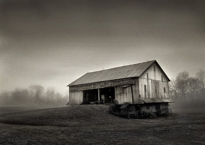 Old barn in foggy field