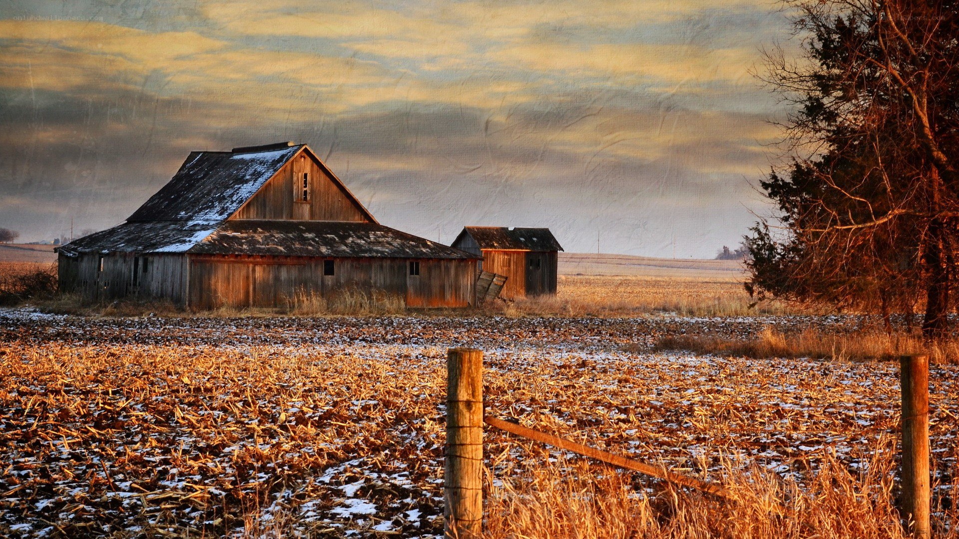 Old barn in snowy field
