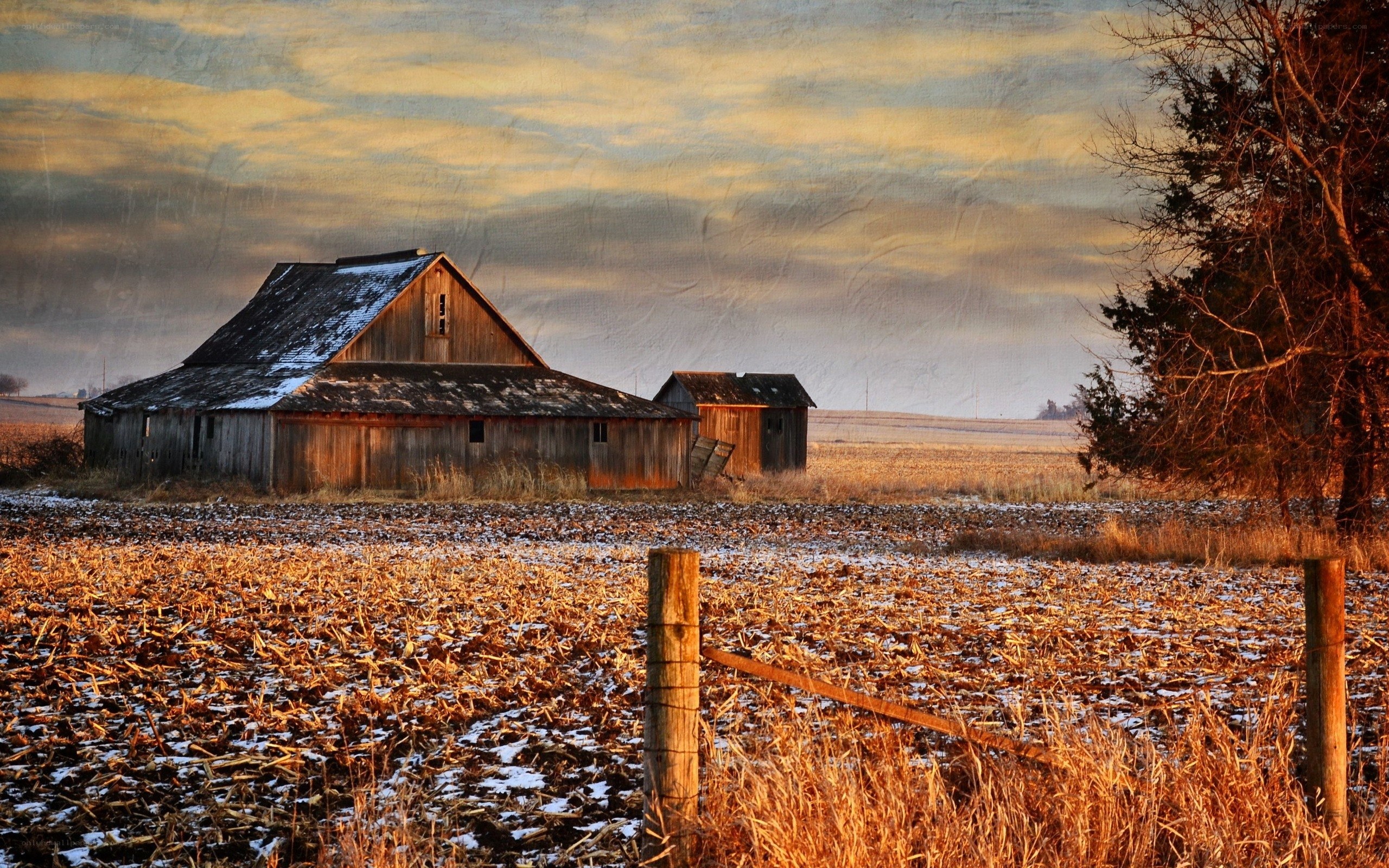 Old barn in snowy field