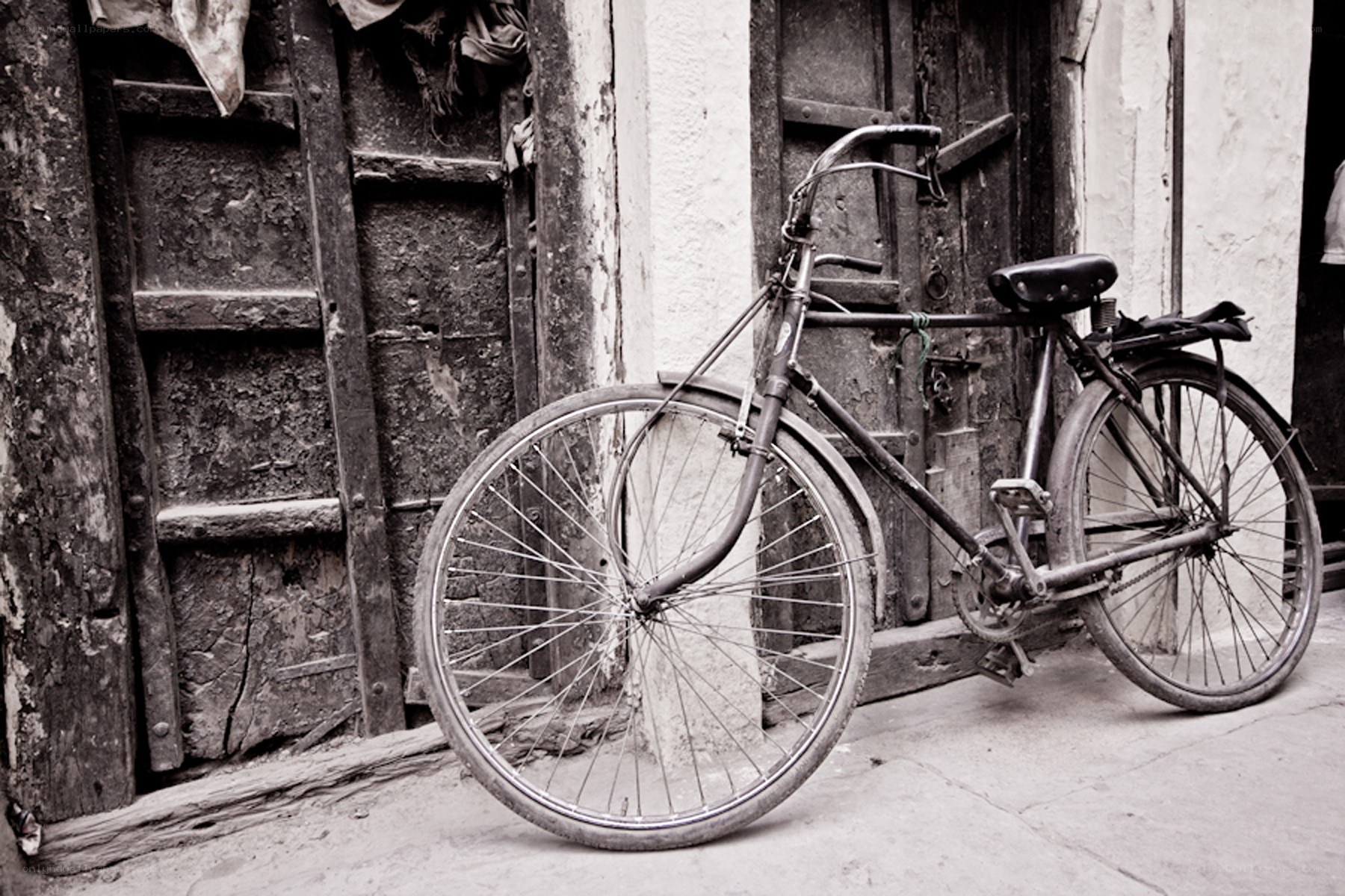 Old bicycle by a wooden door