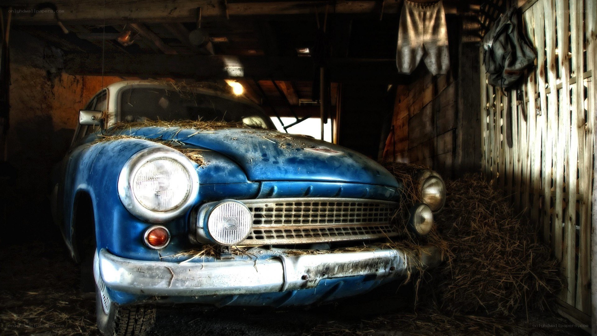 Old blue car in barn