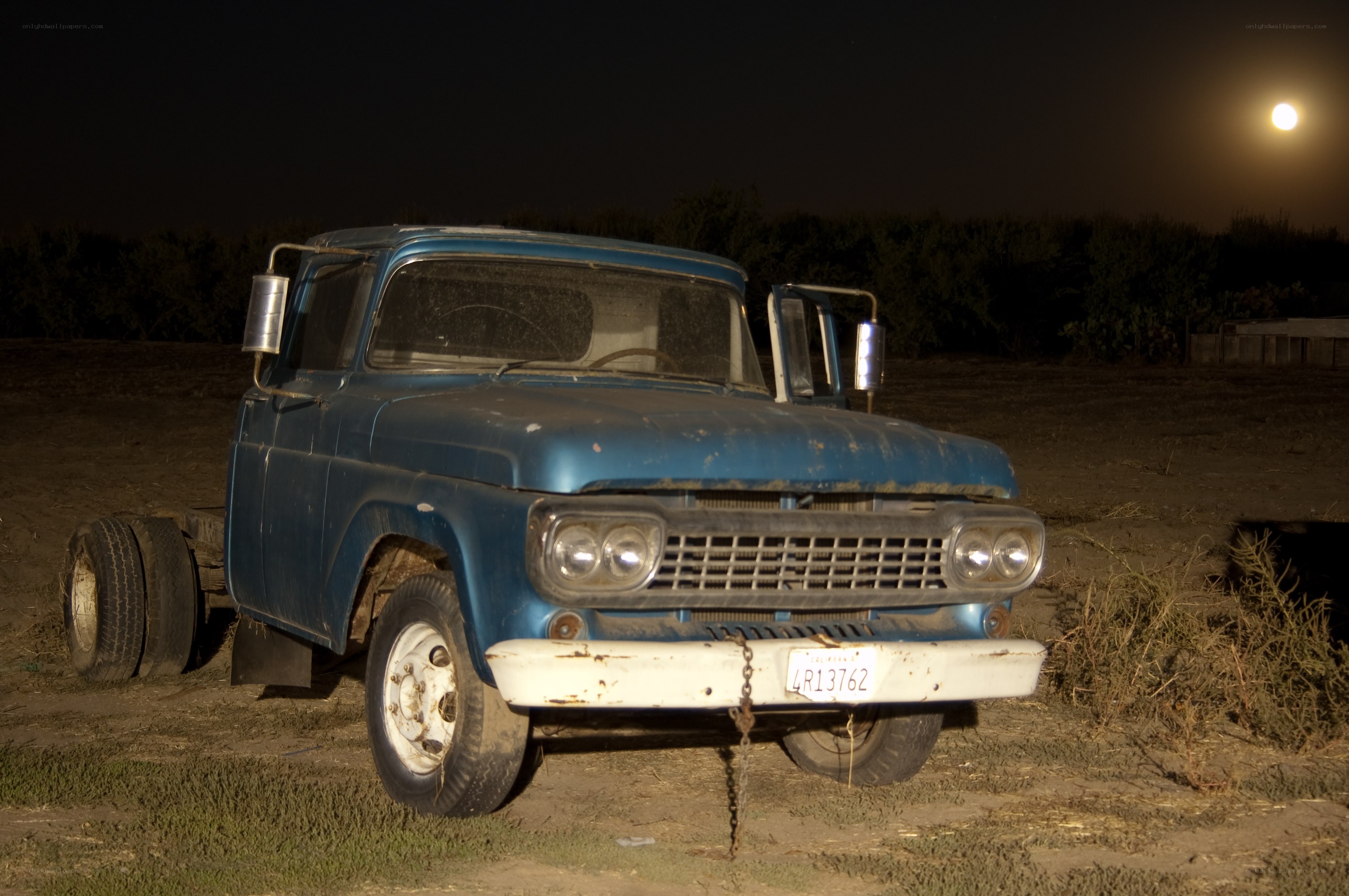 Old blue truck at night