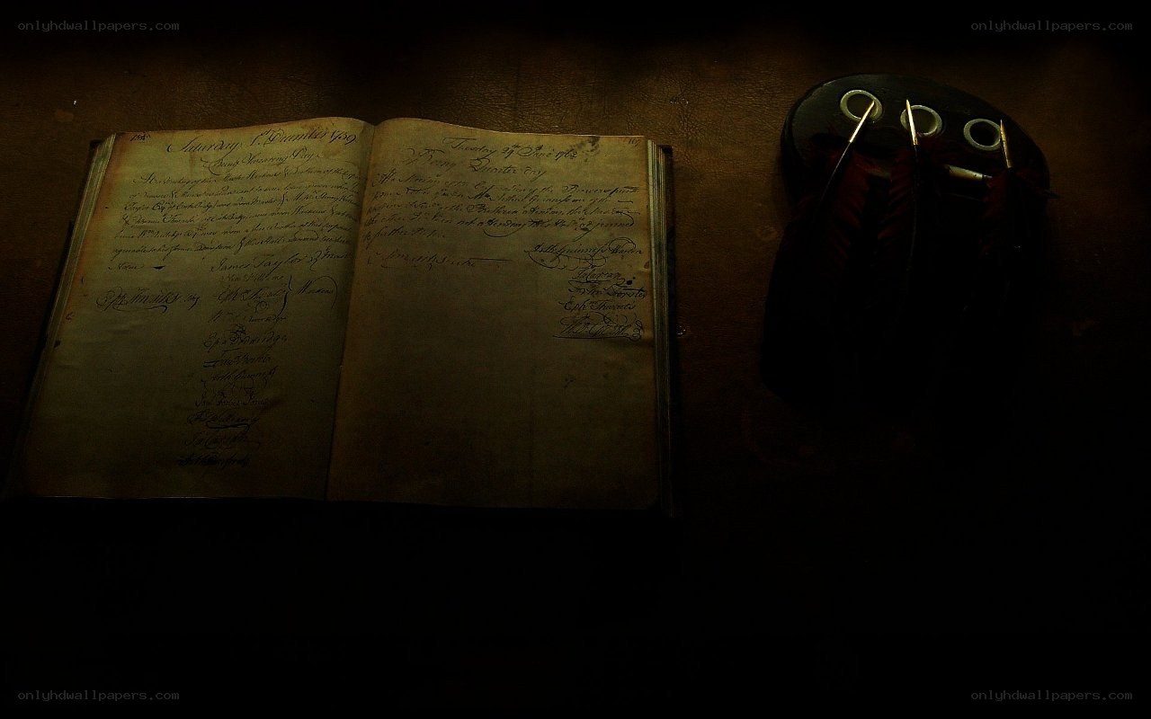 Old book and quill on table