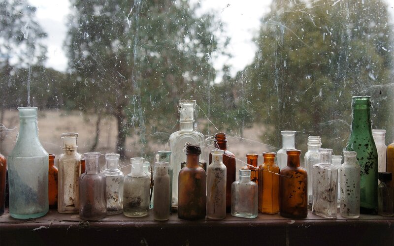 Old bottles on a dusty windowsill