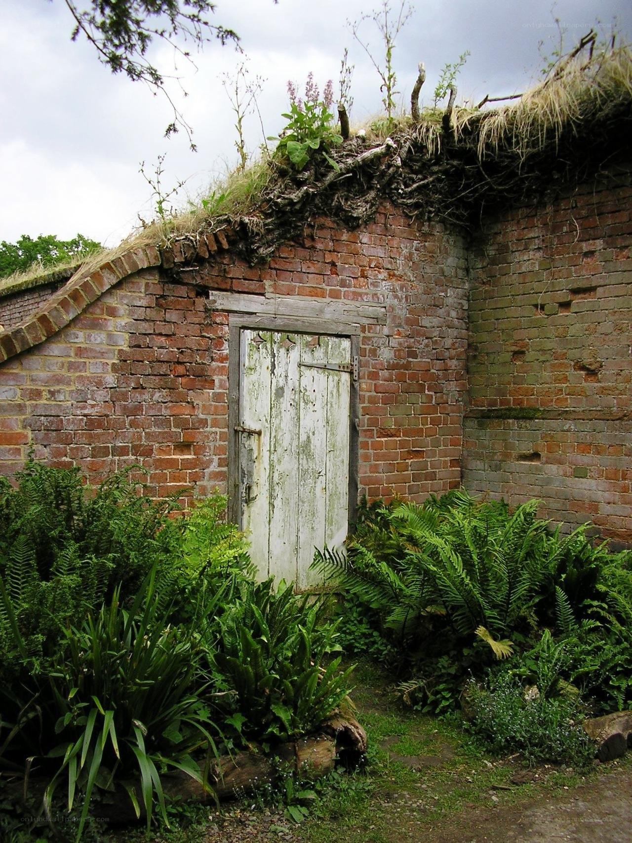 Old brick shed with grass roof