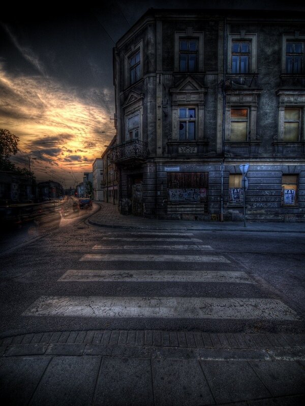 Old building at sunset on wet street