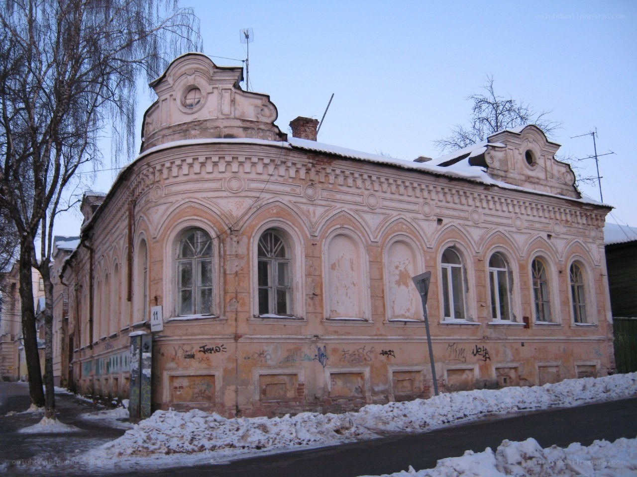 Old building with graffiti in winter