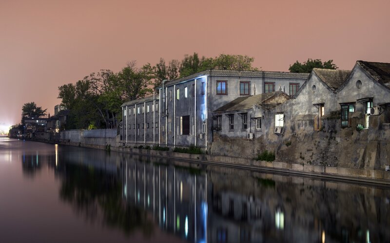 Old buildings along a canal at dusk