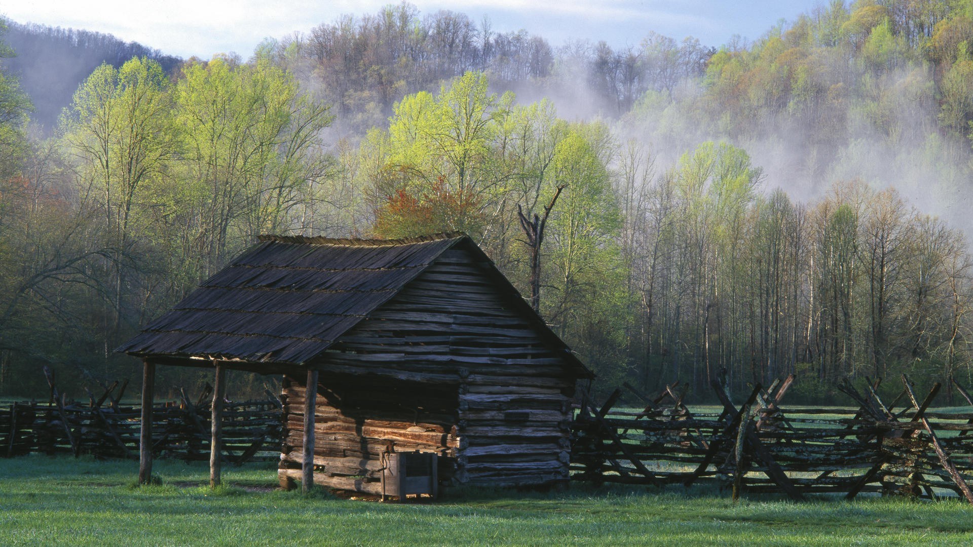 Old cabin in a misty valley