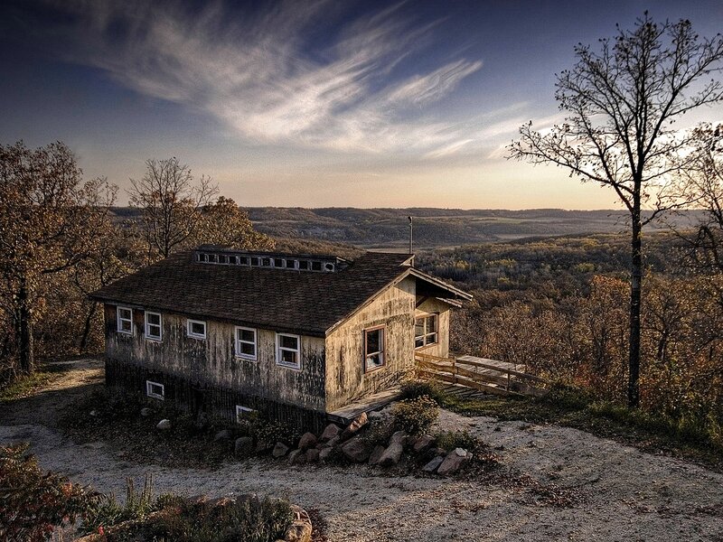 Old cabin on a hill at sunset