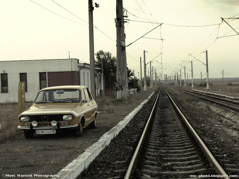 Old car by train tracks