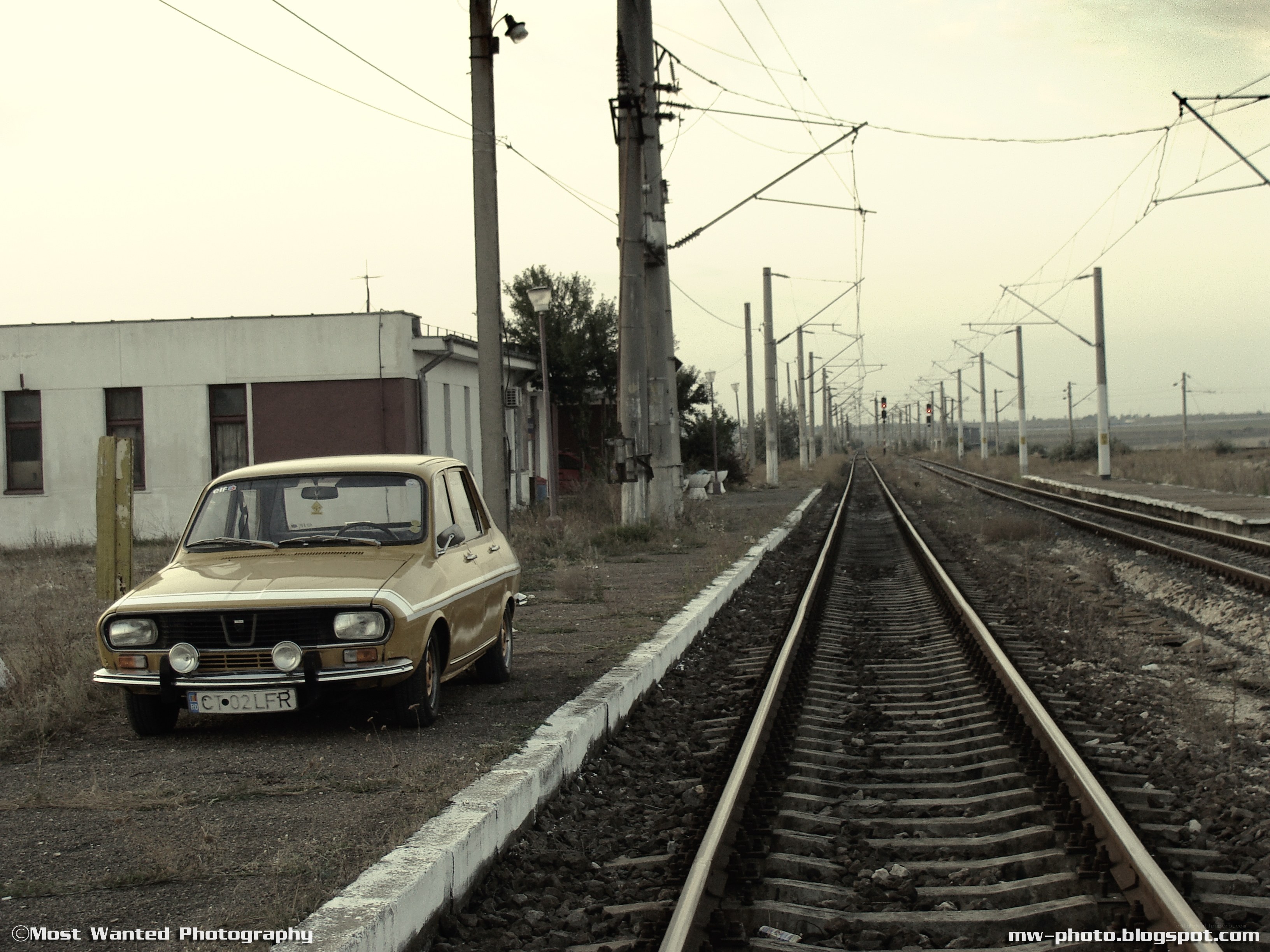 Old car by train tracks