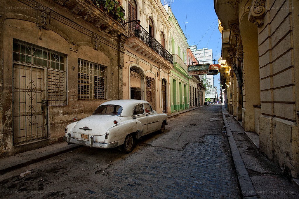 Old car on cobblestone street