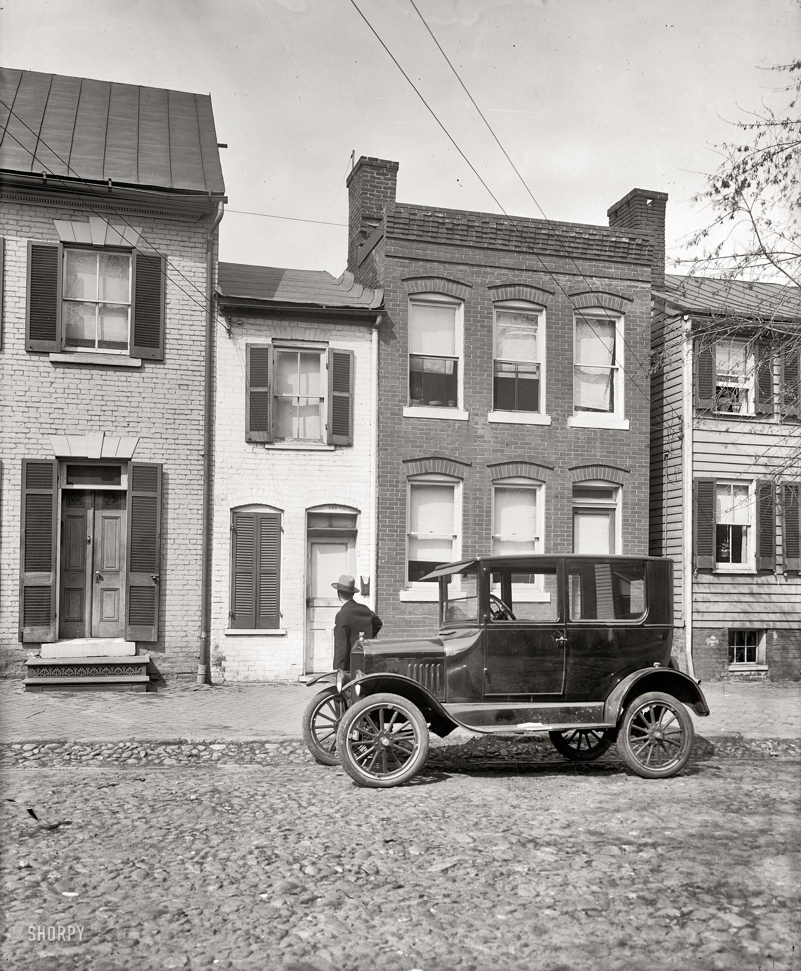 Old car on cobblestone street