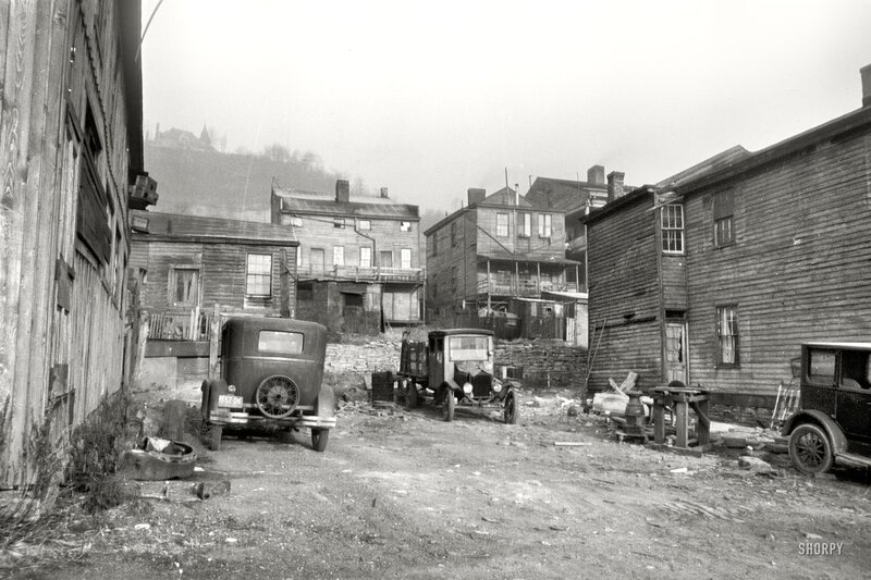 Old cars in a rundown alley