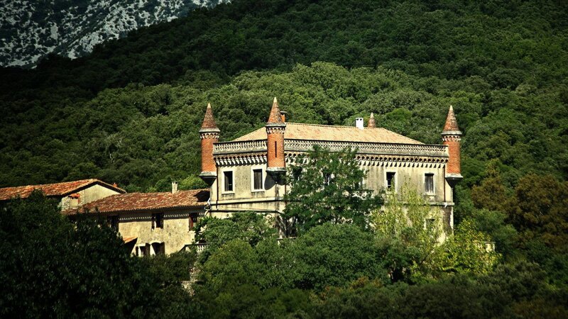 Old castle in forested mountains