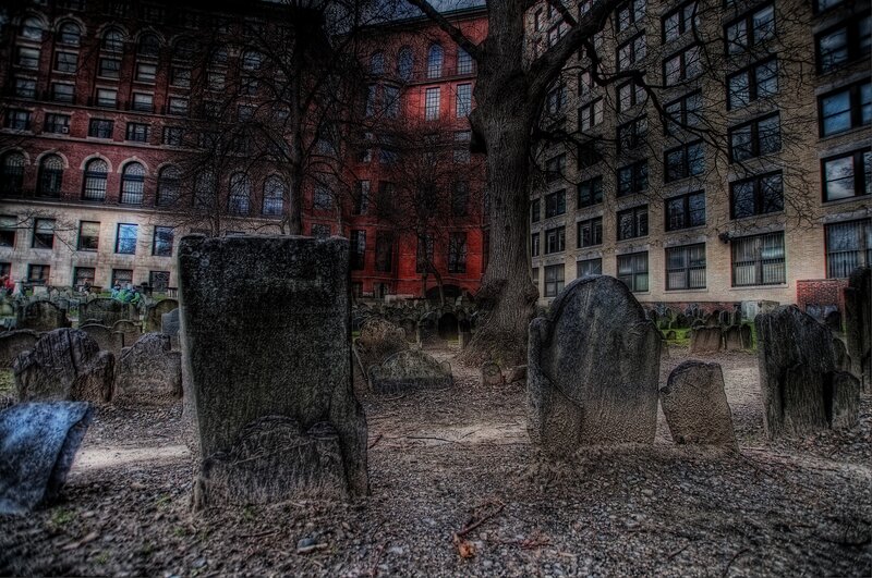 Old cemetery with city buildings