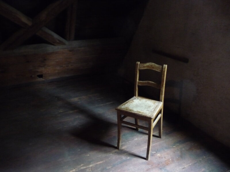 Old chair in a dark attic