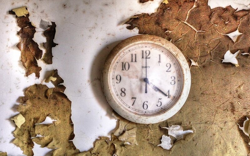 Old Clock on Peeling Wall