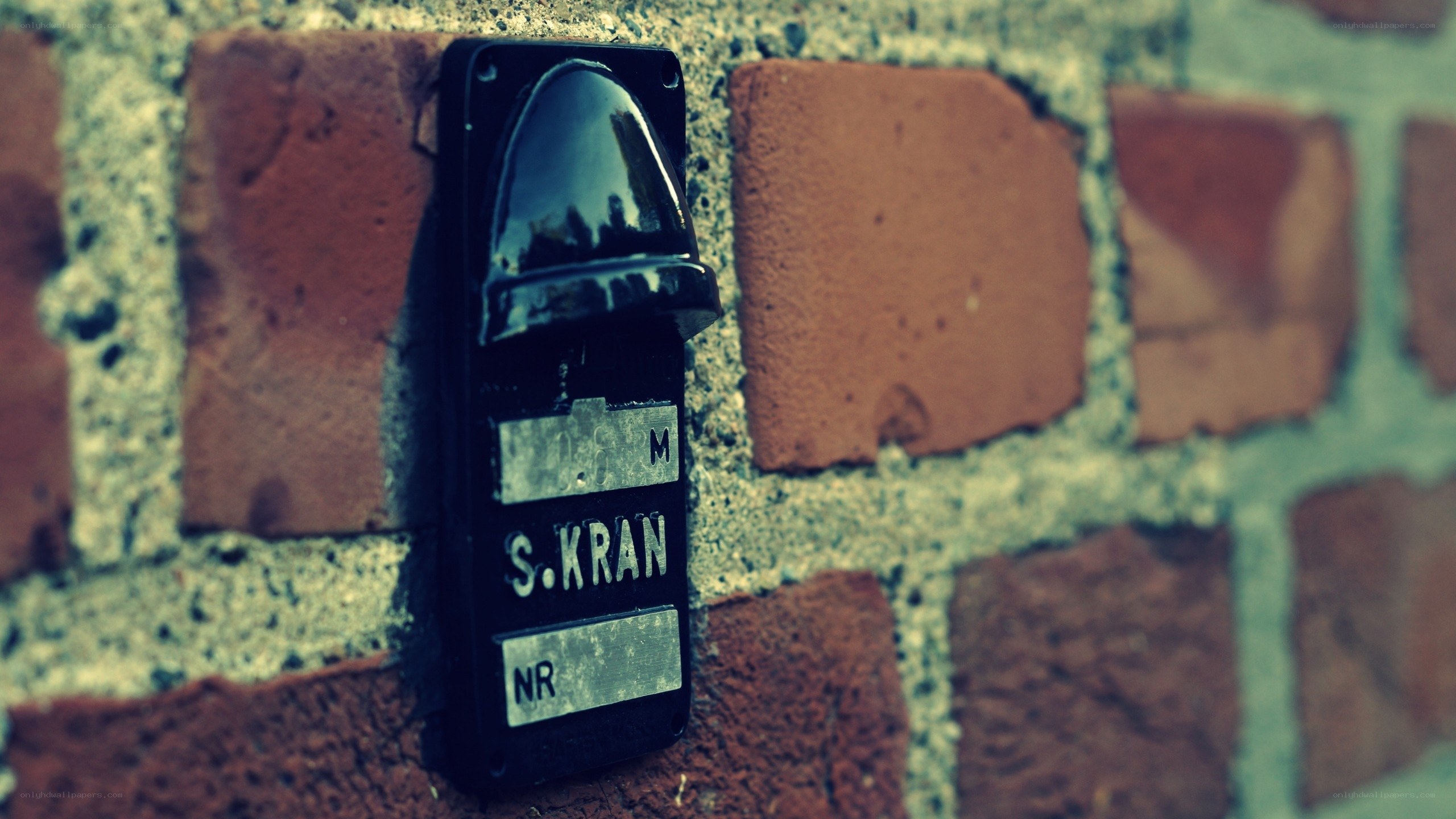 Old doorbell on brick wall