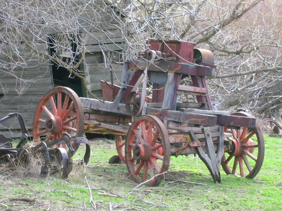 Old farm equipment in grass