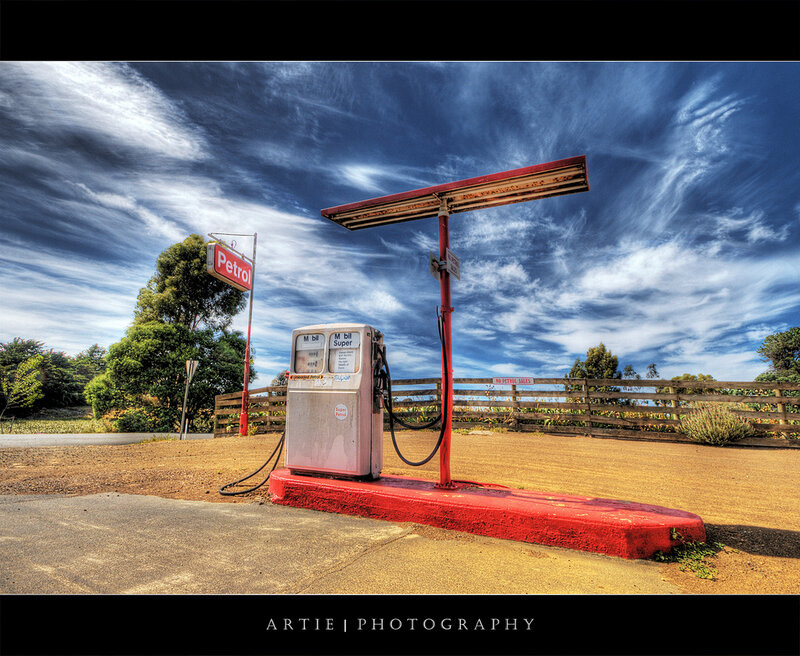 Old gas pump under cloudy sky