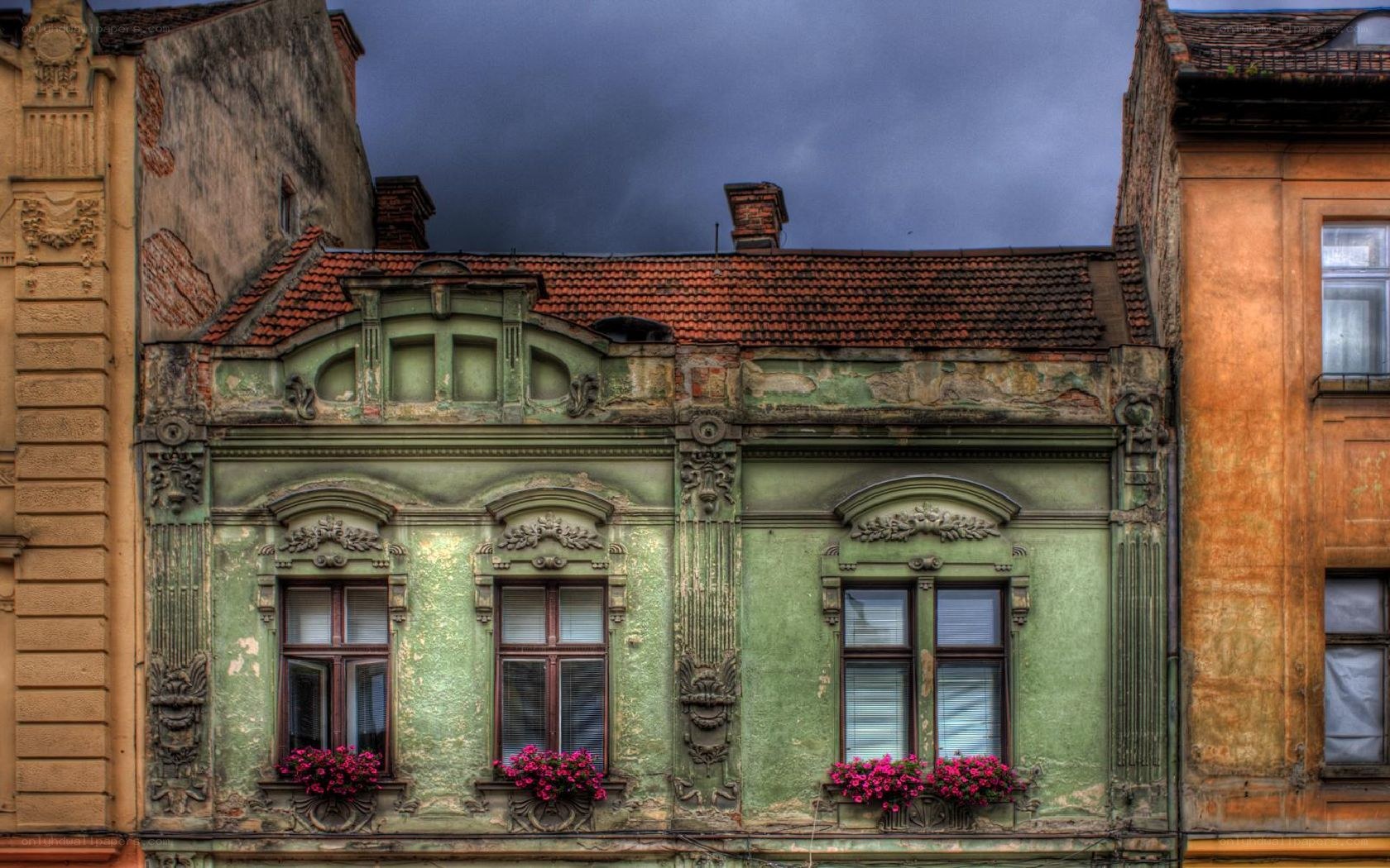 Old green building with flower boxes