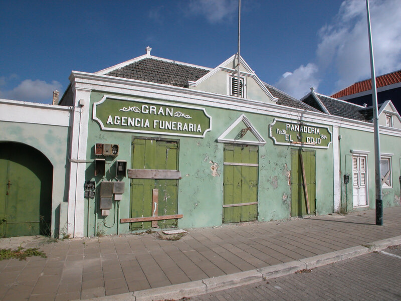 Old green building with signs