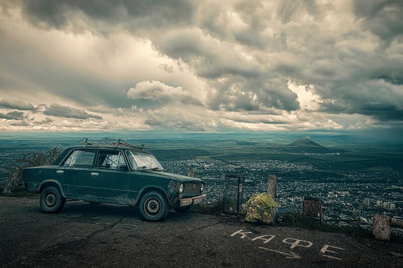 Old Green Car on Cliff