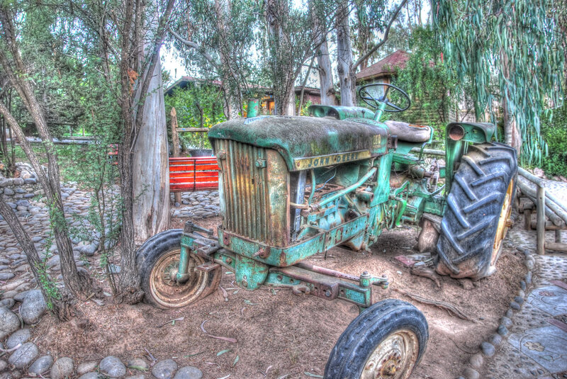 Old green tractor in garden