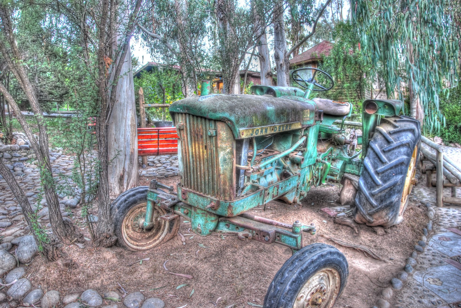 Old green tractor in garden