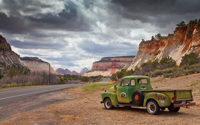 Old green truck on desert road