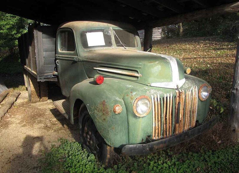 old green truck under shelter