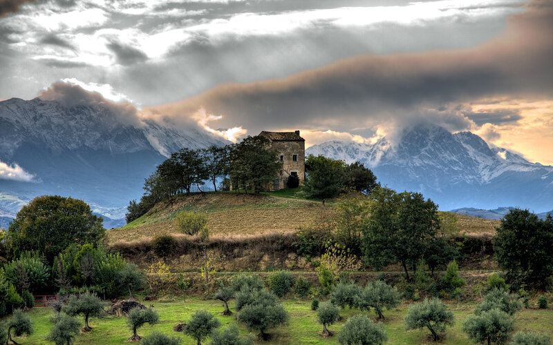 Old house on a hill with mountains