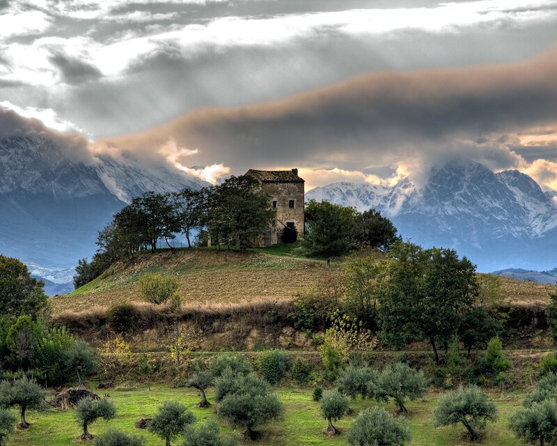 Old house on a hill with mountains