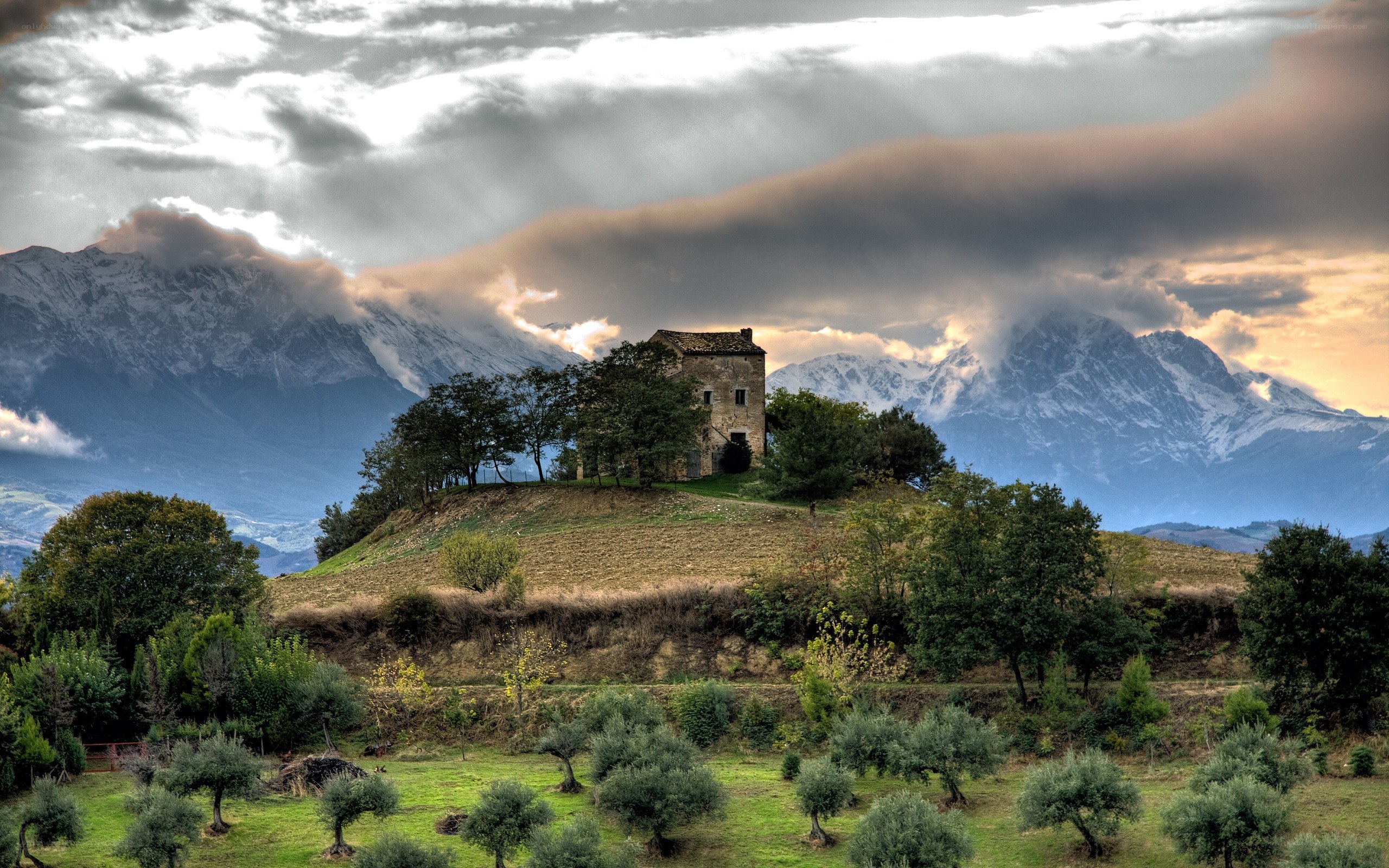 Old house on a hill with mountains