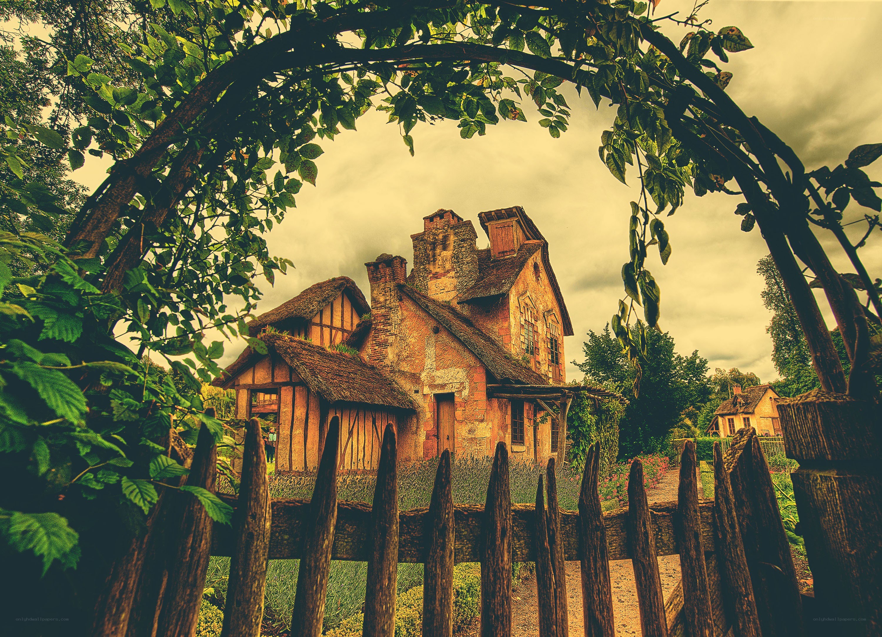 Old house through garden arch