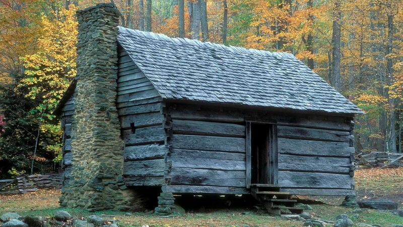 Old log cabin in autumn forest