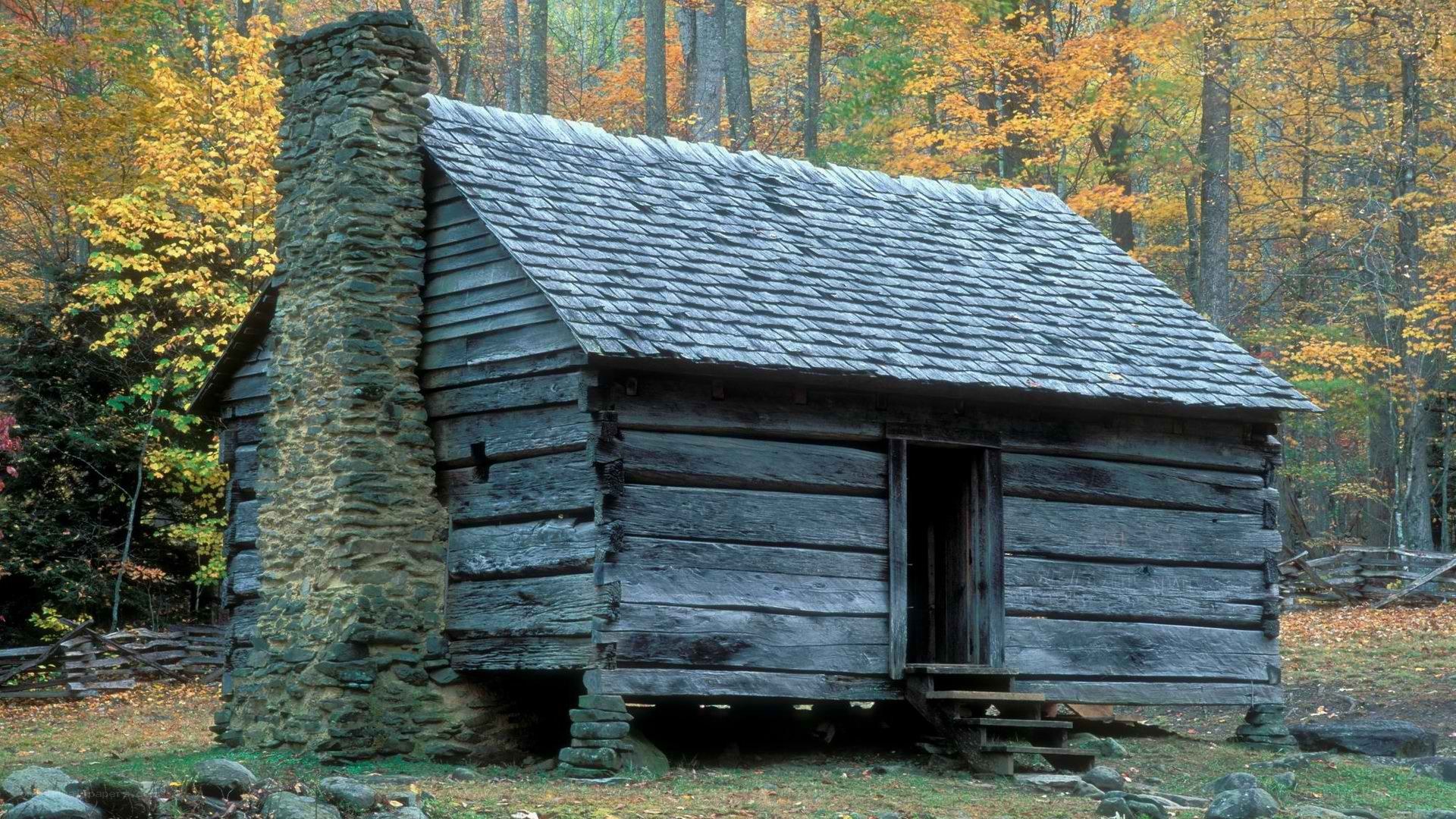 Old log cabin in autumn forest