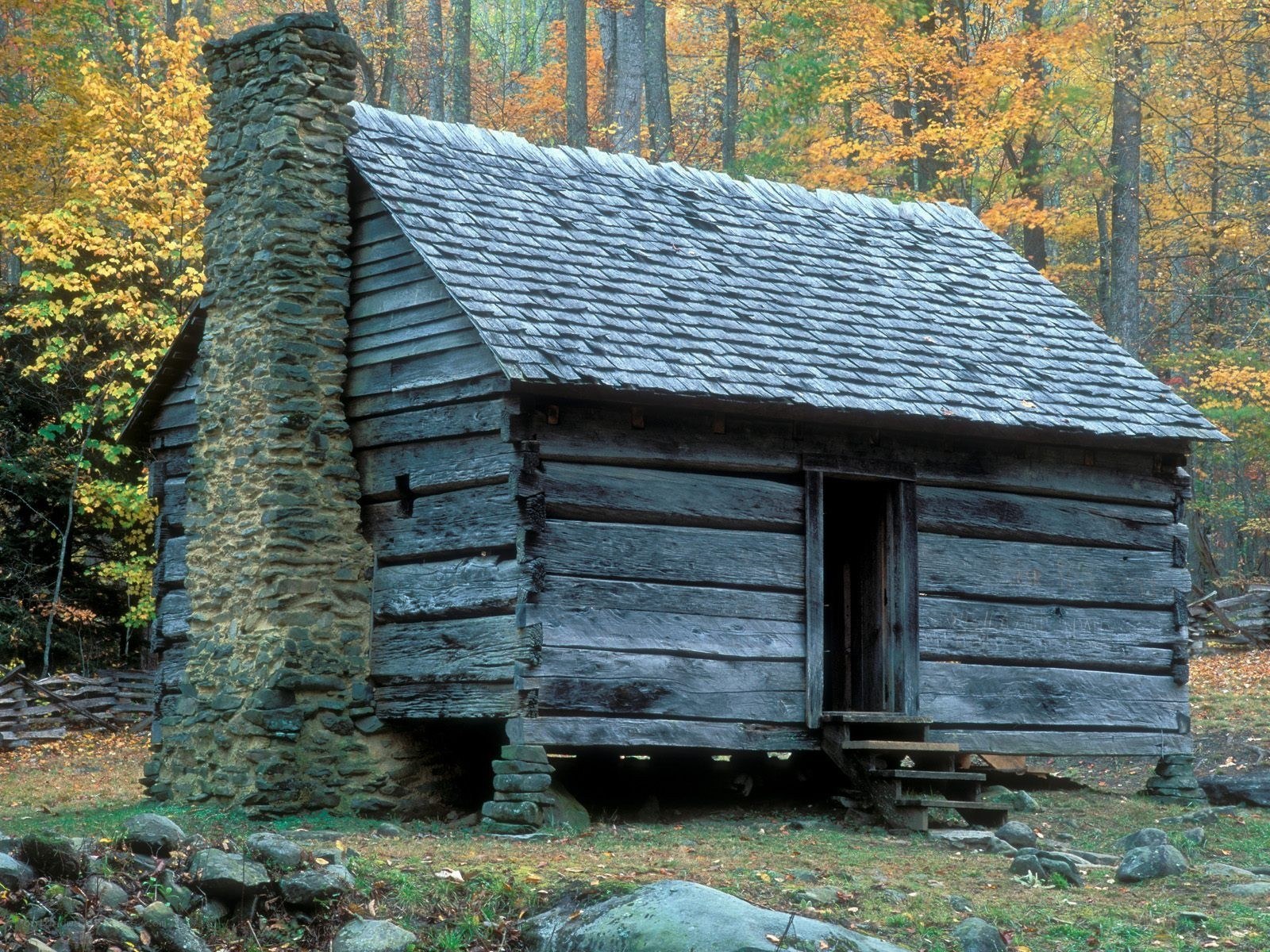 Old log cabin in autumn forest